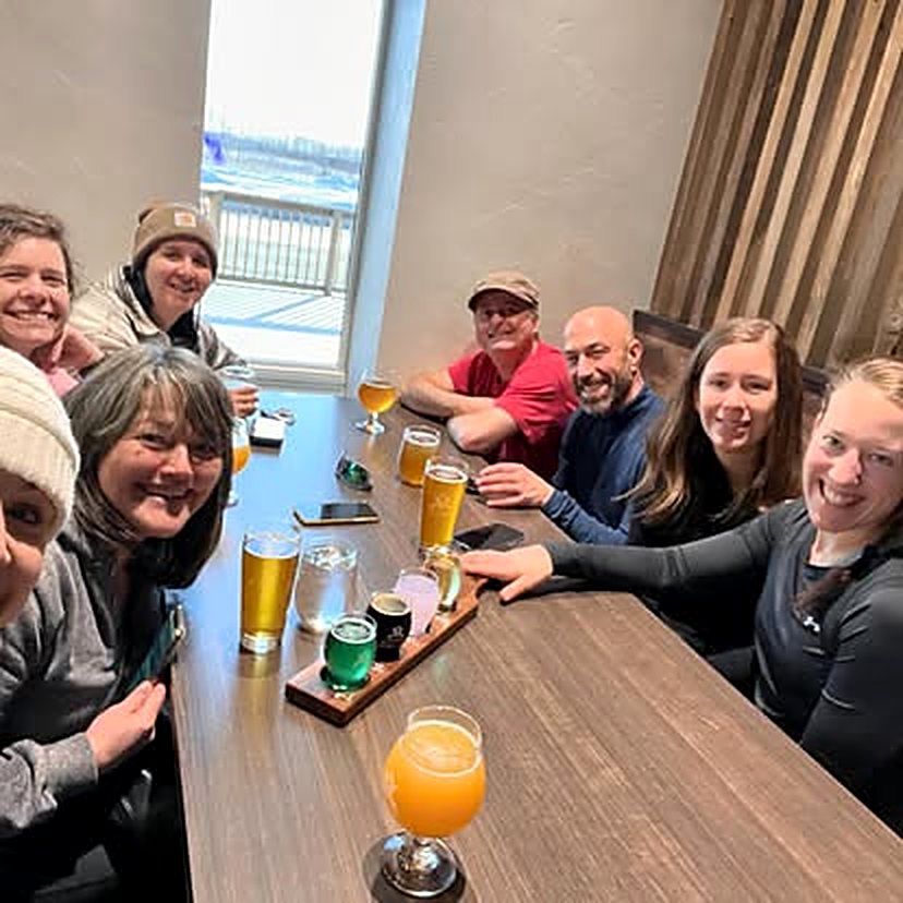 Premium Fitness members smiling around a table together